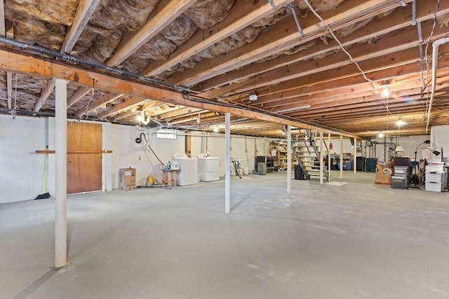 unfinished basement featuring separate washer and dryer