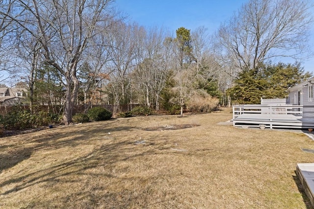 view of yard featuring fence and a deck