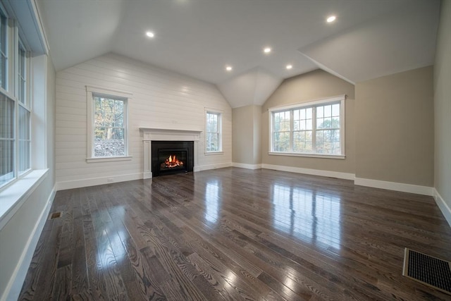 unfurnished living room featuring dark hardwood / wood-style flooring and vaulted ceiling