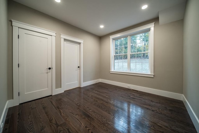 unfurnished bedroom featuring dark wood-type flooring