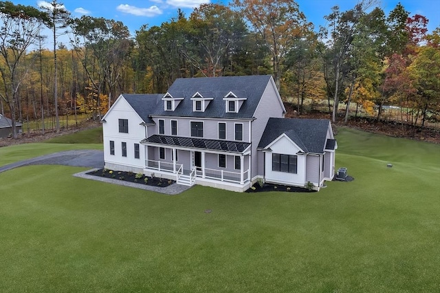 back of house featuring a yard, central AC unit, and a porch