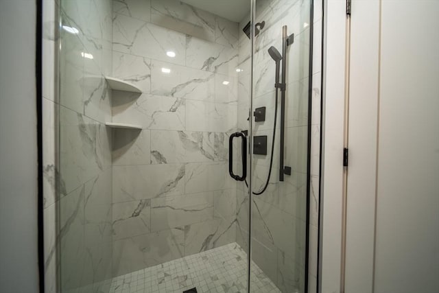 bathroom with a shower with shower door