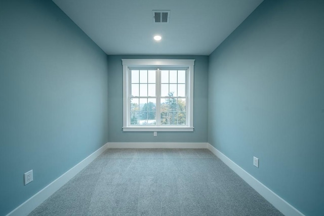 unfurnished room with light carpet