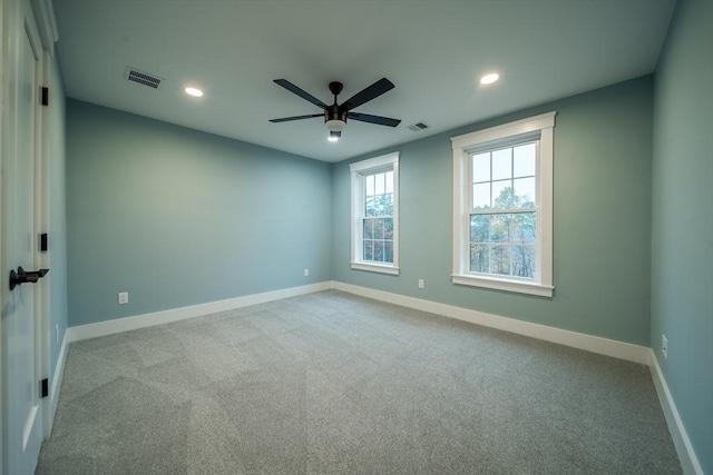 carpeted spare room featuring ceiling fan