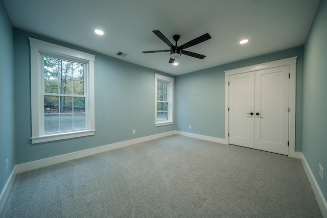 unfurnished bedroom with carpet and ceiling fan