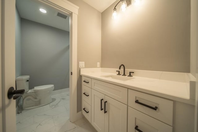 bathroom with vanity and toilet