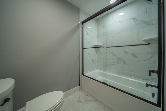 bathroom featuring combined bath / shower with glass door and toilet