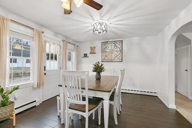 dining room featuring dark wood-type flooring and a baseboard heating unit