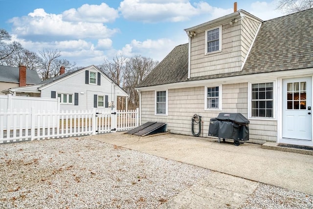 back of property with a patio