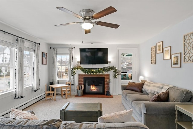 carpeted living room with a fireplace, baseboard heating, and ceiling fan