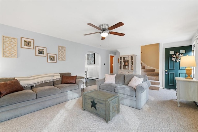 living room featuring ceiling fan, baseboard heating, and light carpet