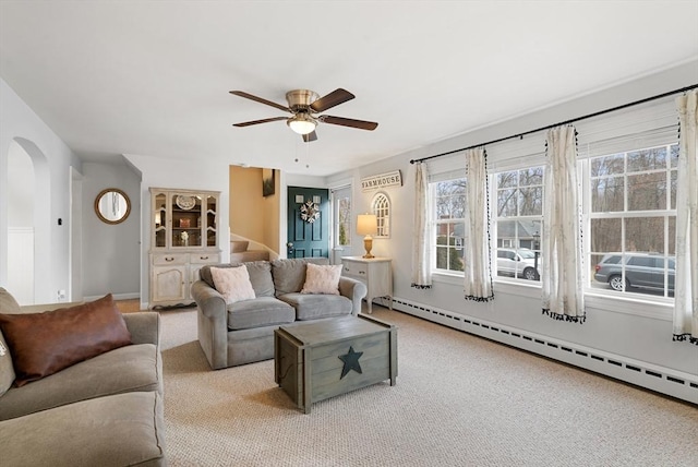 carpeted living room featuring ceiling fan and a baseboard radiator