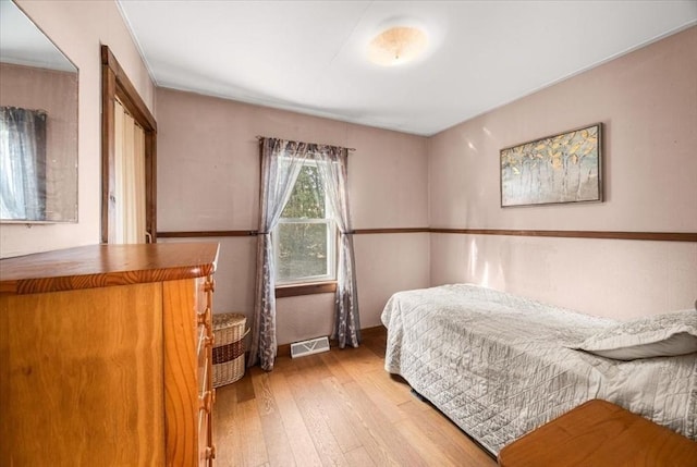 bedroom featuring visible vents and wood-type flooring