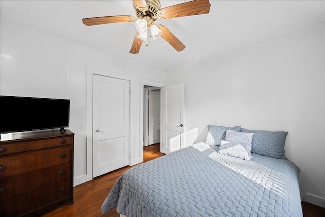 bedroom featuring baseboards, ceiling fan, and wood finished floors