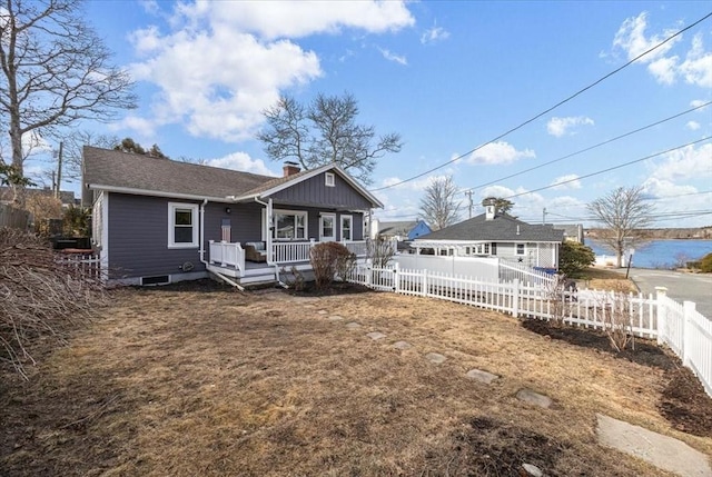 back of property featuring a porch, a chimney, and fence