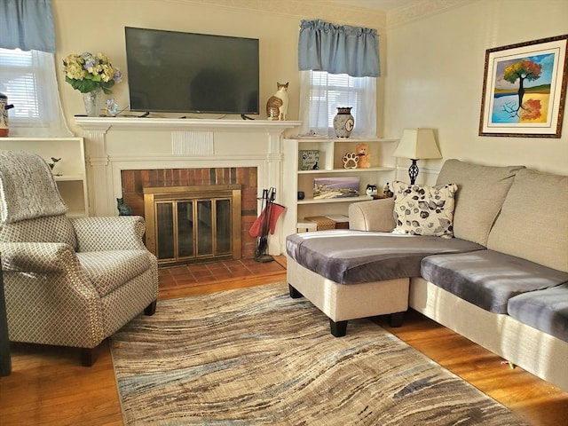 living room featuring wood-type flooring and a fireplace