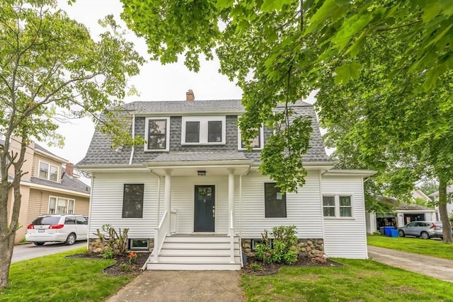 5 Winthrop Ave, Marblehead, MA 01945 - view of front of property featuring a shingled roof, a front yard, and a chimney