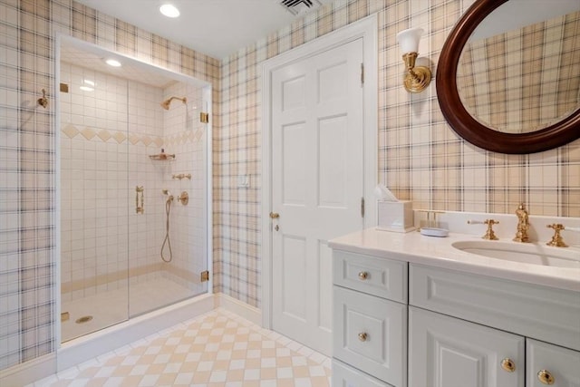 full bath with visible vents, a shower stall, vanity, and wallpapered walls