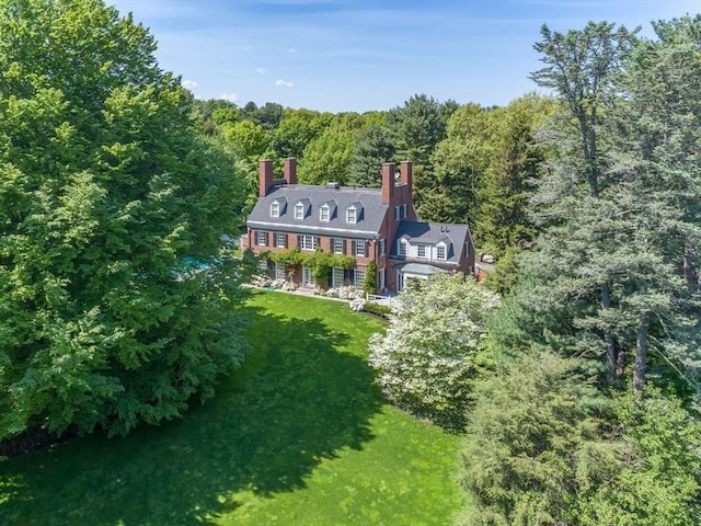 birds eye view of property featuring a view of trees