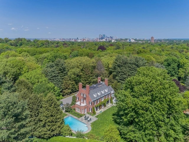 bird's eye view with a city view and a wooded view