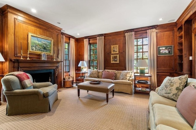 sitting room featuring recessed lighting, light colored carpet, a fireplace, and wood walls