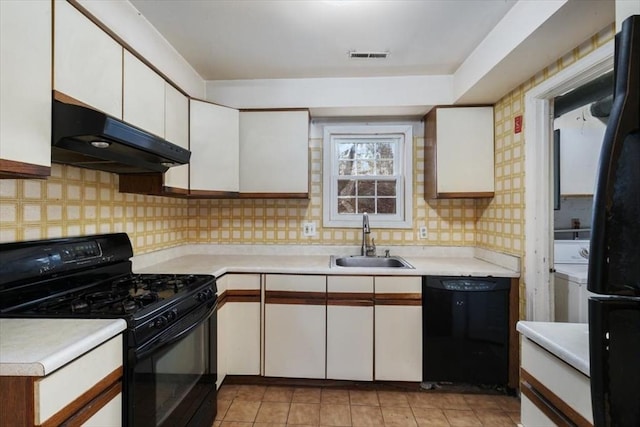 kitchen featuring black appliances, white cabinets, and sink