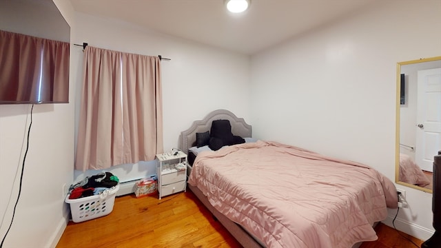 bedroom with hardwood / wood-style flooring