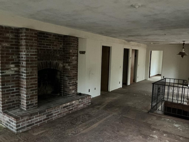 unfurnished living room with a brick fireplace