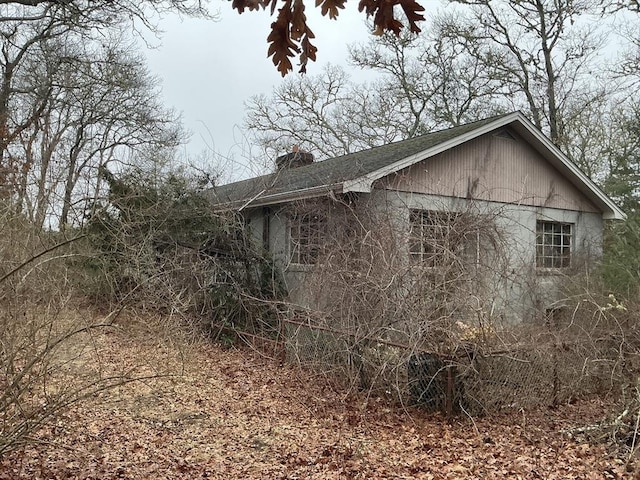 view of side of home featuring a chimney