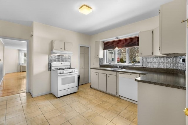 kitchen featuring sink, white appliances, radiator, tasteful backsplash, and light tile patterned flooring