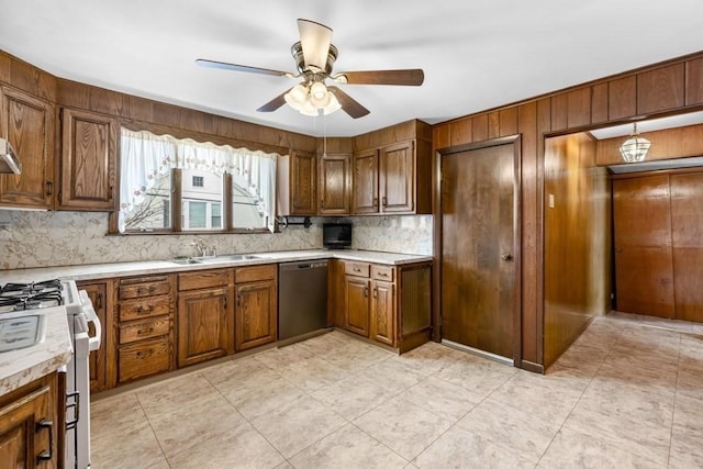 kitchen featuring sink, ceiling fan, white gas range, decorative backsplash, and stainless steel dishwasher