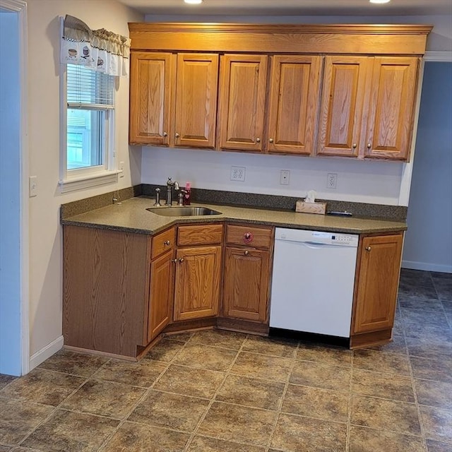 kitchen featuring white dishwasher and sink