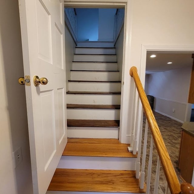 staircase with wood-type flooring