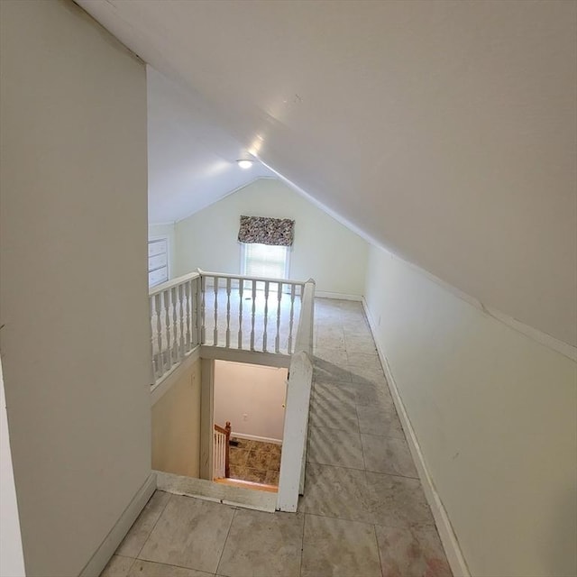 stairway featuring lofted ceiling