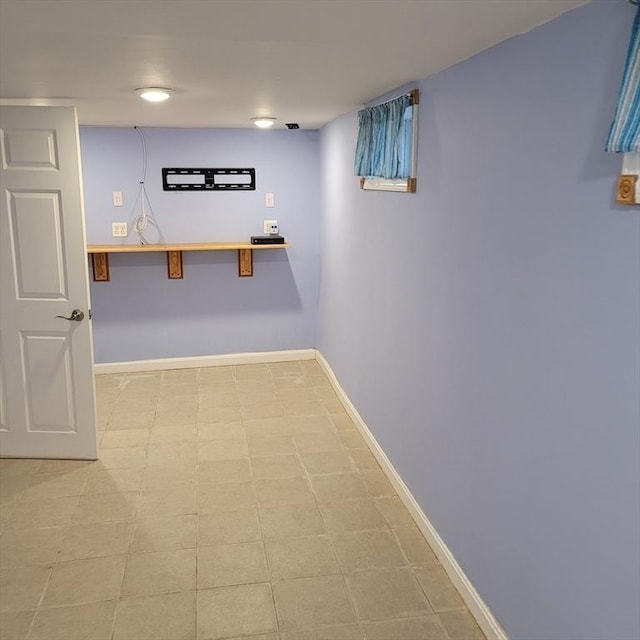 basement featuring light tile patterned floors