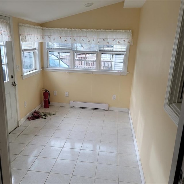 tiled empty room featuring a healthy amount of sunlight, lofted ceiling, and a baseboard radiator