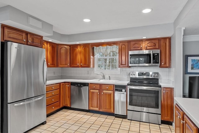 kitchen featuring tasteful backsplash, stainless steel appliances, and sink