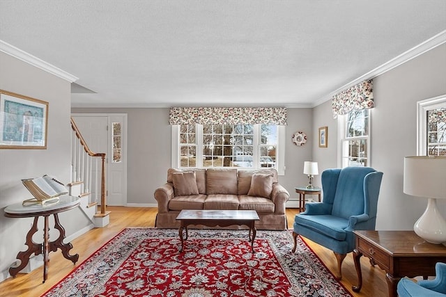 living room featuring a baseboard heating unit, crown molding, and light hardwood / wood-style floors