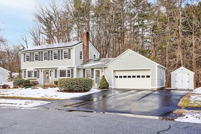 view of front of home featuring a garage and a shed