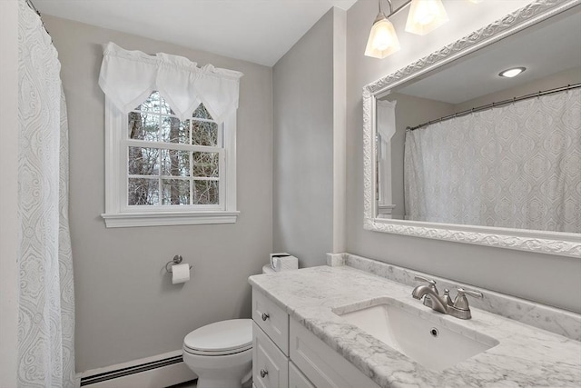 bathroom with vanity, toilet, and a baseboard heating unit