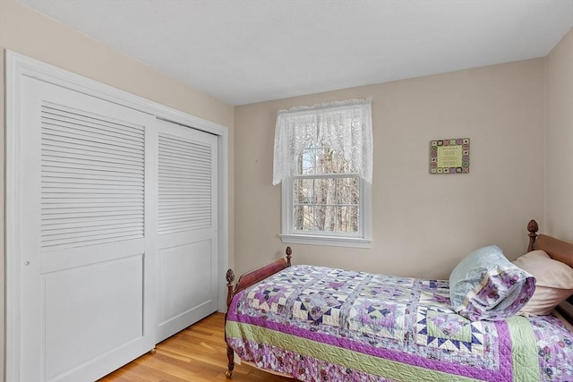 bedroom featuring light wood-type flooring and a closet