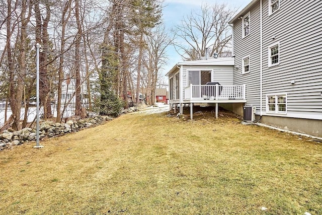 view of yard featuring cooling unit and a deck