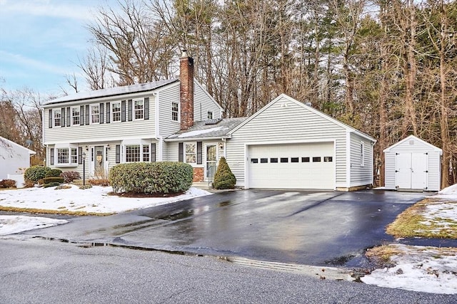 view of front of home featuring a garage and a storage unit