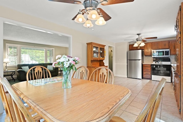 112 Stoddard Dr, North Attleboro, MA 02760 - dining room with ceiling fan, light tile patterned floors, and baseboards