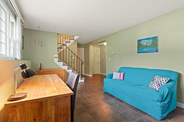112 Stoddard Dr, North Attleboro, MA 02760 - living room with stairs, dark tile patterned floors, and baseboards