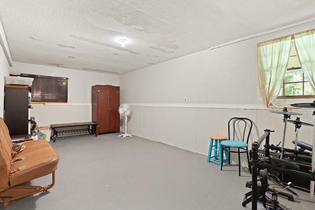 112 Stoddard Dr, North Attleboro, MA 02760 - sitting room with a textured ceiling, concrete flooring, and a wainscoted wall