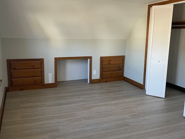 bonus room featuring light hardwood / wood-style flooring and lofted ceiling