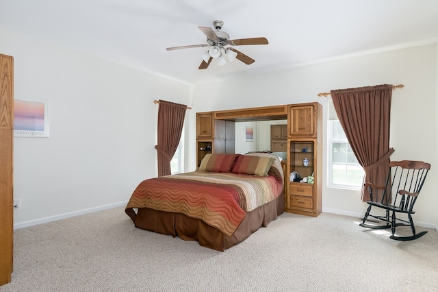 bedroom with light carpet and ceiling fan