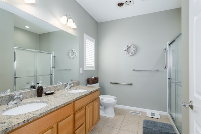 bathroom with vanity, toilet, tile patterned floors, and an enclosed shower