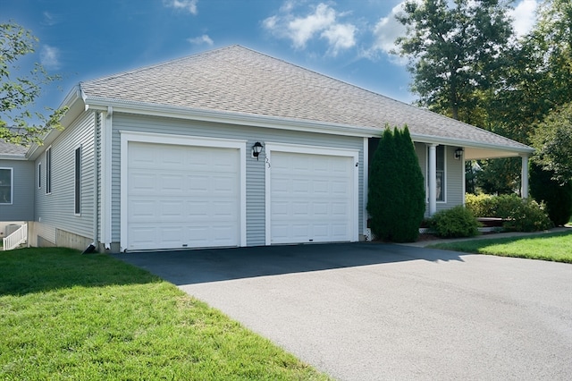 view of front of property with a front lawn and a garage